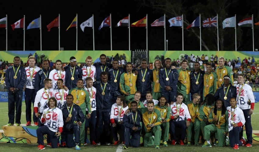 2016 Rio Olympics - Rugby - Men's Victory Ceremony - Deodoro Stadium - Rio de Janeiro, Brazil - 11/08/2016. Players from Britain, Fiji and South Africa pose for photos at the victory ceremony.